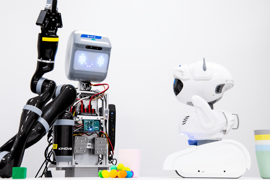Two robots work together in a lab at Tufts University.
