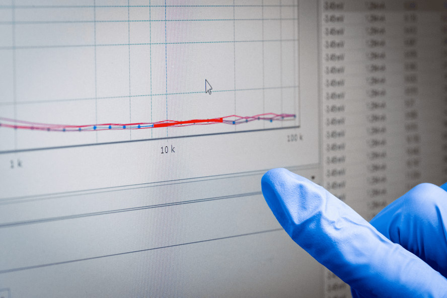 A finger posts to a graph of data on a screen in the Green Energy and Nanostructured Electronics Lab.