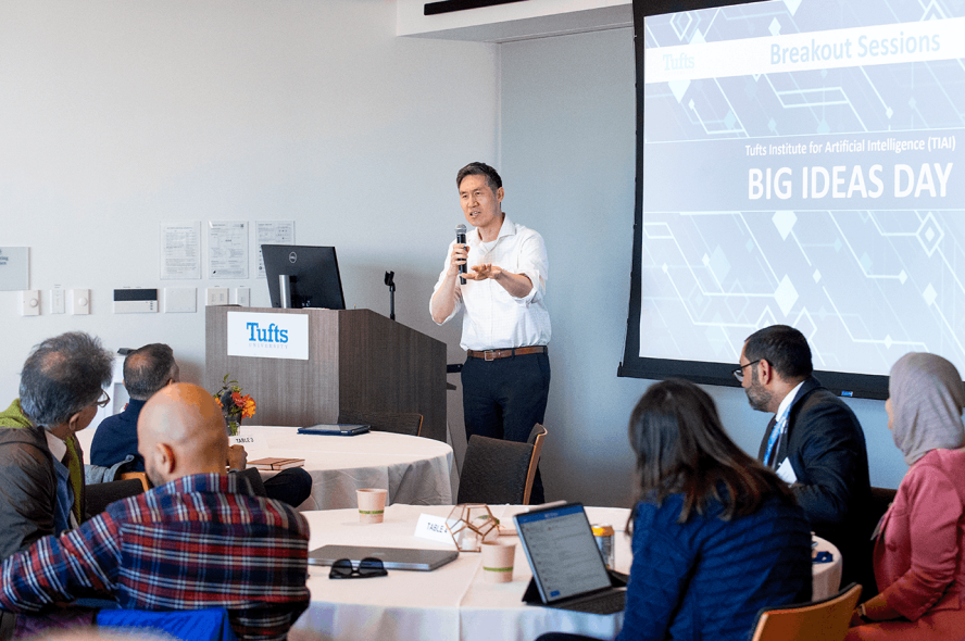 A faculty member speaks to researchers during TIAI Big Ideas Day.