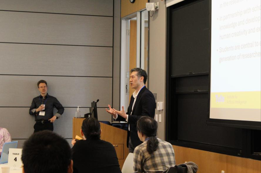 Dean Lee addresses the audience in a classroom.
