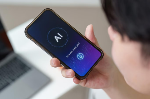 A person holding a phone with the screen saying AI